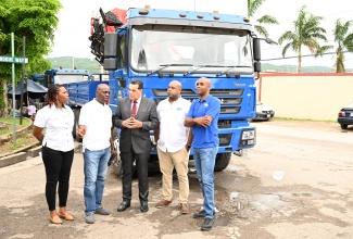 Executive Director, National Solid Waste Management Authority (NSWMA), Audley Gordon (second left), speaks with Minister of State in the Office of the Prime Minister (West), Hon. Homer Davis (centre), during the relaunch of Operation SWEEP at WPM Limited's office at Freeport in Montego Bay, St. James, on June 27. Also pictured are (from left) Operations Director of NSWMA, Aretha McFarlane; Deputy Mayor of Montego Bay, Councillor Dwight Crawford; and Regional Operations Manager of WPM Waste Management Limited, Edward Muir.  

