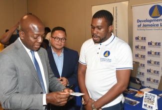 Minister of Labour and Social Security, Hon. Pearnel Charles Jr. (left) and Chairman, Jamaica Productivity Centre, Omar Azan (centre), engage with Relationship Executive, Development Bank of Jamaica, Travell Mullings, during the Future of Work and Productivity seminar at the AC Kingston Hotel in St. Andrew on June 20. The event is being held under the theme ‘Bridging the Innovation and Productivity Gaps: Education, Skills and Economic Transformation’.