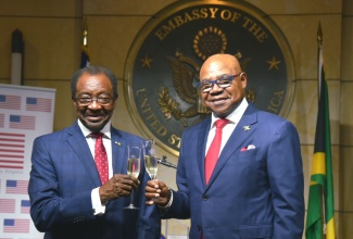 Minister of Tourism, Hon. Edmund Bartlett (right) and United States (US) Ambassador to Jamaica, His Excellency N. Nickolas Perry, raise a toast during the reception held at the US Embassy in Kingston on June 26 to celebrate the 248th anniversary of independence of the US. July 4 is Independence Day in the US, marking the day in 1776 when the Declaration of Independence was adopted, signalling the official separation of the 13 original colonies from Great Britain.
