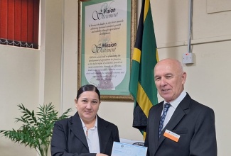 Chief Executive Officer of the Rural Agricultural Development Authority (RADA), Marina Young, receives a cheque from Lead Researcher for the Mitigating Effects of Heat Stress in Caribbean Animal Production Project, Langston University in the United States (US), Dr. Ryszard Puchala. The initiative, which is being facilitated through partnership with the Rural Agricultural Development Authority (RADA), will benefit nine small ruminant farmers across the country.

