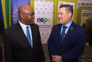 Minister without Portfolio in the Ministry of Economic Growth and Job Creation, Senator the Hon. Matthew Samuda (right), converses with Chief Executive Officer, National Environment and Planning Agency (NEPA), Leonard Francis, during Wednesday’s (June 5) symposium on ecosystems restoration, in observance of World Environment Day, at The Summit in New Kingston.