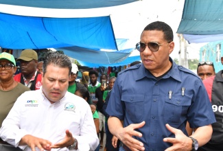 Prime Minister the Most Hon. Andrew Holness (right) and Minister without Portfolio in the Ministry of Economic Growth and Job Creation, Senator the Hon. Matthew Samuda (left), tour a section of the Ocho Rios market in St. Ann on Friday (June 21). The tour formed part of a working visit to the parish by the Prime Minister.