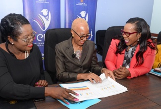 Minister of Education and Youth, Hon. Fayval Williams (centre), conversess with Permanent Secretary in the Ministry, Dr. Kasan Troupe (right), and Acting Chief Education Officer, Terry Ann Thomas Gayle, as they view the 2024 Primary Exit Profile (PEP) results during a press conference on Friday (June 21) at the Ministry’s offices in Kingston.