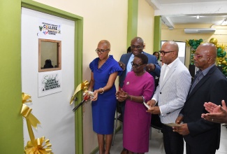 Minister of Education and Youth, Hon. Fayval Williams (left), cuts the ribbon to officially open the Science, Technology, Engineering and Mathematics (STEM) Robotics Centre at Excelsior Community College’s Eureka Road Campus in Kingston on Thursday (June 13). Sharing in the exercise (from second left) are Principal, Philmore McCarthy; President, Jamaica Methodist District in the Caribbean and the Americas, Rev. Bishop Christine Gooden Benguche; Chief Executive Officer, e-Learning Jamaica Limited, Andrew Lee; and Chairman, Committee of Management, Lloyd Davis.