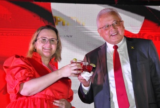 High Commissioner of Canada in Jamaica, Her Excellency Emina Tudakovic (left) and Minister of Justice, Hon. Delroy Chuck, share a toast during a Canada Day Reception held on Tuesday (June 25) at the official residence of the Canadian High Commissioner in Kingston.

