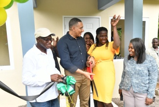 Prime Minister, the Most Hon. Andrew Holness (second left), looks on while new homeowner Cassandra Pryce (second right) proudly displays the keys to her new house in Bartons, St. Catherine, on Friday (June 7), which was provided under the New Social Housing Programme (NSHP). Sharing the moment (from left) are Member of Parliament for St. Catherine South Western, Everald Warmington; and Chairperson of the NSHP Oversight Committee, Judith Robb Walters.