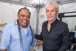 Well-known American singer Michael Bolton (right) shares a moment with Marketer, Sean Edwards, prior to the start of the recent Issa Trust Foundation benefit concert at Sans Souci Resort in St. Mary.

