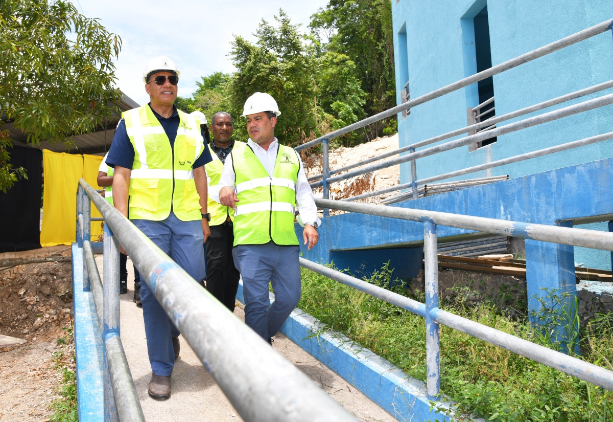 Prime Minister the Most Hon. Andrew Holness (left) and Minister without Portfolio in the Ministry of Economic Growth and Job Creation, Senator the Hon. Matthew Samuda (right), tour the new classroom block being constructed at the Exchange All -Age School in Ocho Rios, St. Ann during a visit on Friday ( June 21). In the (background) is the school’s principal, Ricardo Moncrieffe.