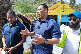 Prime Minister, the Most Hon. Andrew Holness (centre), converses with Minister of Agriculture, Fisheries and Mining, Hon. Floyd Green (left), and Mayor of Black River, Councillor Richard Solomon, during a tour of St. Elizabeth on Thursday (July 4) to assess the impact of Hurricane Beryl on the parish.