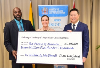 Minister of Foreign Affairs and Foreign Trade, Senator the Hon. Kamina Johnson Smith (centre), and Acting Director General of the Office of Disaster Preparedness and Emergency Management (ODPEM), Richard Thompson (left), receive a cheque valued at $7.5 million from Chinese Ambassador to Jamaica, Chen Daojiang, to assist Jamaica’s Hurricane Beryl recovery efforts.  The handover ceremony was held at the Ministry’s offices in downtown Kingston on Tuesday (July 16). 
