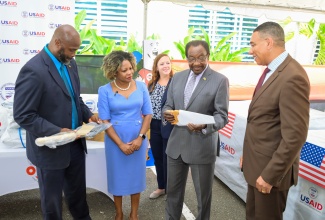 Prime Minister, the Most Hon. Andrew Holness (right), in discussion with United States (US) Ambassador to Jamaica, His Excellency Nickolas N. Perry (second right); USAID Acting Country Representative, Erin Taylor (centre); Minister without Portfolio with responsibility for Information, Skills and Digital Transformation, Senator Dr. the Hon. Dana Morris Dixon; and Acting Director General, Office of Disaster Preparedness and Emergency Management (ODPEM), Richard Thompson, during Tuesday’s (July 30) handover of emergency relief supplies, valued US$360,000, which were donated by the US to assist Jamaica’s Hurricane Beryl recovery efforts. The presentation was made at ODPEM’s Haining Road offices in Kingston. 

