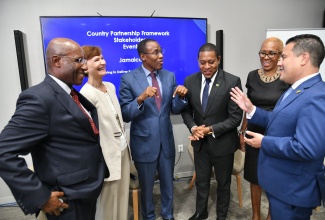 Minister of Finance and the Public Service, Dr. the Hon. Nigel Clarke (third left), exchanges banter with Minister without portfolio in the Ministry of Economic Growth and Job Creation, Senator the Hon. Matthew Samuda (right), at the recent World Bank country partnership framework event at the AC Marriott in Kingston. Others (from left) are Minister of Industry, Investment and Commerce, Senator the Hon. Aubyn Hill; World Bank Country Director, Lilia Burunciuc; Minister of Agriculture, Fisheries and Mining, Hon. Floyd Green; and Minister of Education and Youth, Hon. Fayval Williams.

