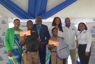 Education Officer, Ministry of Education & Youth, Yvonne Hardie (left), with two of the recipients of financial help and back-to-school supplies, from the Barracks Road Primary School, Ashawni Reid and Jermaine Garfield, at a treat held at Pier One in Montego Bay, St James, by New Fortress Energy, on Wednesday, July 31. Others (from second left) are  Custos of St. James, Bishop the Hon. Conrad Pitkin; Vice President, New Fortress Energy, Verona Carter; Deputy Mayor of Montego Bay, Councillor Dwight Crawford and Third Vice President, Montego Bay Chamber of Commerce and Industry (MBCCI), Paulette Neil. 