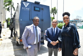 Deputy Prime Minister and Minister of National Security, Hon. Dr. Horace Chang (centre), shakes hands with Founder and Chief Executive Officer (CEO) of ECHE Limited, Lititia Myers Gray (right), during a visit by Ms. Gray to the Ministry’s offices in Kingston on Wednesday (July 17), to showcase the company’s newly acquired fleet of armored vehicles. Sharing the moment is Commissioner of Police, Dr. Kevin Blake.

