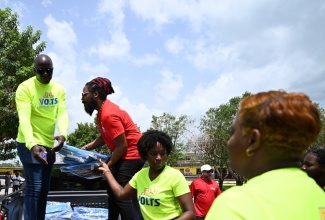 Representatives from Digicel Foundation and Jamaica Public Service (JPS) Foundation unload tarpaulins for distribution to residents of St. Elizabeth impacted by the recent passage of Hurricane Beryl. The entities, in collaboration with Flow Foundation and Food For the Poor, delivered care packages to residents of Parottee, Slipe and Crawford, among other areas on July 10.

