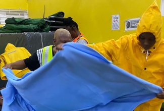 Workers prepare cots at one of the emergency shelters in St. Catherine on Wednesday (July 3).

