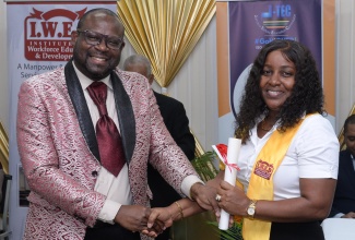 Regional Director of Region 1, Otis Brown (left), presents Moneke Mattocks with her certificate at the Jamaica-Tertiary Education Commission’s (J-TEC) Food Service Worker Certification Ceremony at George Headley Primary School in Kingston on Friday (July 12). The event saw the award of certificates to school-based food service workers who participated in a pilot project to certify individuals through the Prior Learning Assessment Recognition (PLAR) programme. The initiative aligns with the Ministry of Education and Youth’s emphasis on the development of persons through certification.