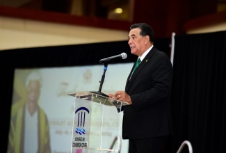 Minister of State in the Office of the Prime Minister (West), Hon. Homer Davis, reads from Lamentations 3:19 during the funeral service for former Speaker of the House of Representatives, Hon. Violet Neilson, which was held at the Montego Bay Convention Centre in St. James on Monday (July 8). Mr. Davis represented Prime Minister, the Most Hon. Andrew Holness.