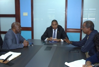 Minister of Agriculture, Fisheries and Mining, Hon. Floyd Green (centre) and Permanent Secretary, Dermon Spence (left), listen attentively as Chief Executive Officer for the National Fisheries Authority (NFA), Dr. Gavin Bellamy, outlines the NFA’s strategies to ensure the safety of fishers and the protection of fisheries-related infrastructure in light of the impending storm. Dr. Bellamy shared the strategies during a strategic meeting held on Monday, July 1 at the Ministry’s Old Hope Road offices in Kingston.