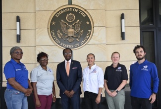 Ambassador N. Nick Perry (third left), poses with 5 of the 12 members from the USAID