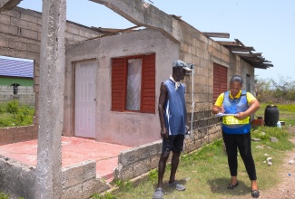 Liaison Officer at the Ministry of Labour and Social Security, Felicia Radlein, records information provided by Lionel Town resident, Adam Blake, on the extent of damages sustained from the passage of Hurricane Beryl. Occasion was a visit to the community in Clarendon on Wednesday (July 10) by teams from the Ministry to assess damages and provide relief items to affected residents.

