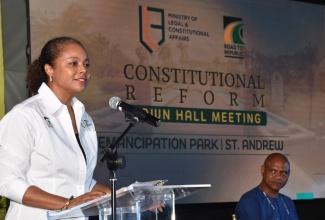 Minister of Legal and Constitutional Affairs, Hon. Marlene Malahoo Forte,  addresses the audience at the Road to Republic Town Hall, held at Emancipation Park in New Kingston on Thursday (July 25). Listening is Deputy Dean, Faculty of Law, University of the West Indies, Mona Campus, Dr. Christopher Malcolm.