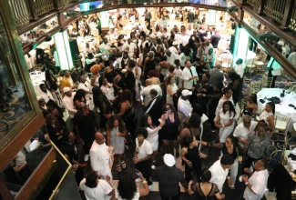 Passengers aboard the ‘Cornucopia Majesty’ dance to the music of DJ Lando Hilpe at the Help Jamaica Medical Mission’s elegant Black and White Cruise, on June 29.