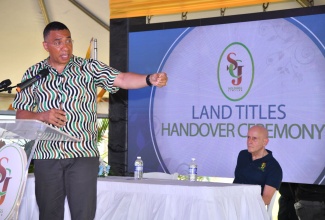 Prime Minister, the Most Hon. Andrew Holness, emphasises a point during a ceremony for the handover of 300 land titles to residents of Clifton in St. Catherine, held at the Clifton Community Centre on Tuesday (July 30). Looking on is Managing Director of SCJ Holdings Jamaica Limited, Joseph Shoucair.

