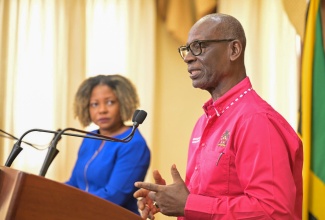 Minister of Local Government and Community Development, Hon. Desmond McKenzie (right), addressing Wednesday’s (July 10) post-Cabinet press briefing at Jamaica House. Looking on is Minister without Portfolio in the Office of the Prime Minister with responsibility for Information, Skills and Digital Transformation, Senator Dr. the Hon. Dana Morris Dixon.

