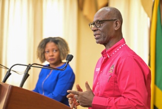 Minister of Local Government and Community Development, Hon. Desmond McKenzie (right), addressing Wednesday’s (July 10) post-Cabinet press briefing at Jamaica House. Looking on is Minister without Portfolio in the Office of the Prime Minister with responsibility for Information, Skills and Digital Transformation, Senator Dr. the Hon. Dana Morris Dixon.