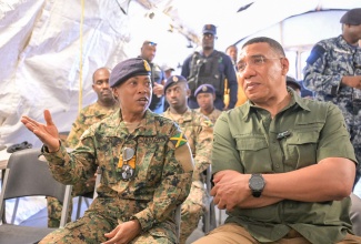 Prime Minister the Most Hon. Andrew Holness (right) is briefed by Chief of Defence Staff (CDS), Vice Admiral Antonette Wemyss Gorman, during a visit to the Jamaica Defence Force (JDF) site in Rocky Point, Clarendon today (July 13). The JDF, including members of the Disaster Assistance Relief Team (DART), has been on the ground providing emergency assistance, clearing debris, and restoring essential services, following the passage of Hurricane Beryl on July 3.