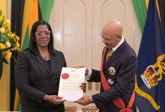 Governor-General, His Excellency the Most Hon. Sir Patrick Allen (right), presents newly appointed President of the Court of Appeal, Hon. Justice Marva McDonald Bishop, with the Instrument of Appointment at the swearing-in ceremony held at King’s House on July 18.