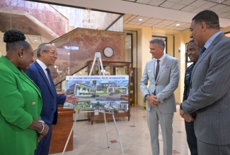 Prime Minister, the Most Hon. Andrew Holness (right), examines the design for the new St. Catherine North Divisional Headquarters of the Jamaica Constabulary Force (JCF), at the Office of the Prime Minister in St. Andrew, on July 23, at the contract-signing ceremony. Also looking at the design (from left) are Minister of Culture, Gender, Entertainment and Sport and Member of Parliament for St. Catherine Central, Hon. Olivia Grange; Deputy Prime Minister and Minister of National Security, Hon. Dr. Horace Chang; Chairman, West Indies Home Contractors (WIHCON) Limited, Peter Melhado; and Commissioner of Police, Dr. Kevin Blake.