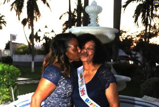 Eighty-year-old Salome Ogilvie (right) receives a kiss from daughter Celia Ogilvie at a special birthday celebration held at Sea Garden Beach Resort in Montego Bay, St. James on August 10.