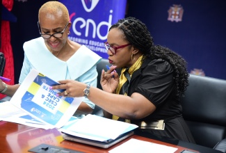 Minister of Education and Youth, Hon. Fayval Williams (left), and Permanent Secretary in the Ministry, Dr. Kasan Troupe, peruse a document during Monday’s (August 26) press conference to provide a report on Jamaica’s performance in the May/June 2024 CSEC and CAPE examinations, at the Ministry’s offices in Kingston.