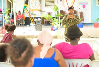 Jamaica Defence Force (JDF) officer, Captain Marcia Chintersingh Henry, addresses residents attending the recent We Care Health Fair at Whitfield Town Church of God in Kingston. The event was organised by the Leela M. Dorman Care Initiative Foundation.