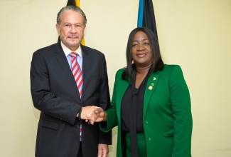 President of the Senate, Senator the Hon. Thomas Tavares-Finson (left), greets President of the Senate of The Bahamas, Senator the Hon. LaShell Adderley, during a courtesy call at Gordon House on Thursday (August 8).