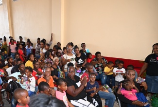 Parents and children gather at the Black River Fire Station in St. Elizabeth on August 9 for a back-to-school fair organised by Jamaicans in the United States.