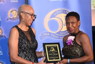 Minister of Education and Youth, Hon. Fayval Williams (left), presents the Contact Teacher Award to educator, Andrene Thompson, at the Jamaica Teachers’ Association (JTA) 60th Annual Conference Awards Ceremony, held at the Ocean Coral Spring in Trelawny, on August 20.