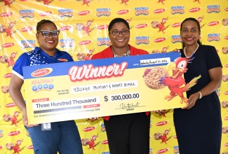 Minister of State in the Ministry of Education and Youth, Hon. Marsha Smith (right), joins Brand Manager at Seprod, Marielle Wade (left), in presenting a cheque to Principal of Village Primary and Infant School in Faiths Pen, St. Ann, Janice Nelson, on Wednesday, August 21, for winning the inaugural