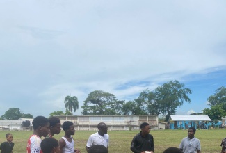 Beneficiaries of the August Town community getting ready for a game of football at the Papine High School.

