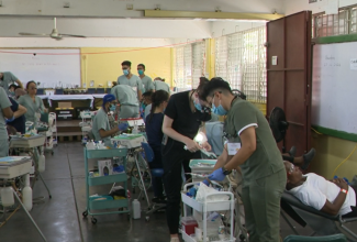Volunteer dental students from the University of Ontario, Canada, and International dental hygienists at work during the 1000 Smiles initiative in St. Ann, at the Ocho Rios High school.