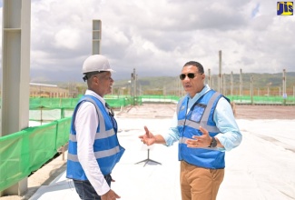 Prime Minister, the Most Hon. Andrew Holness (right), converses with Factories Corporation of Jamaica (FCJ) Chairman, Lyttleton Shirley, during a tour of the Morant Bay Urban Centre earlier this year.

