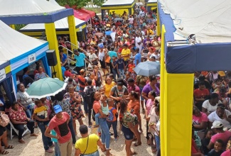 Patrons flock the various booths during a back-to-school fair held at B.B. Coke High School in Junction, St. Elizabeth, on August 9. The fair was hosted by the Jamaica Public Service (JPS) Foundation, Flow Foundation and the Digicel Foundation, in partnership with Food For the Poor.