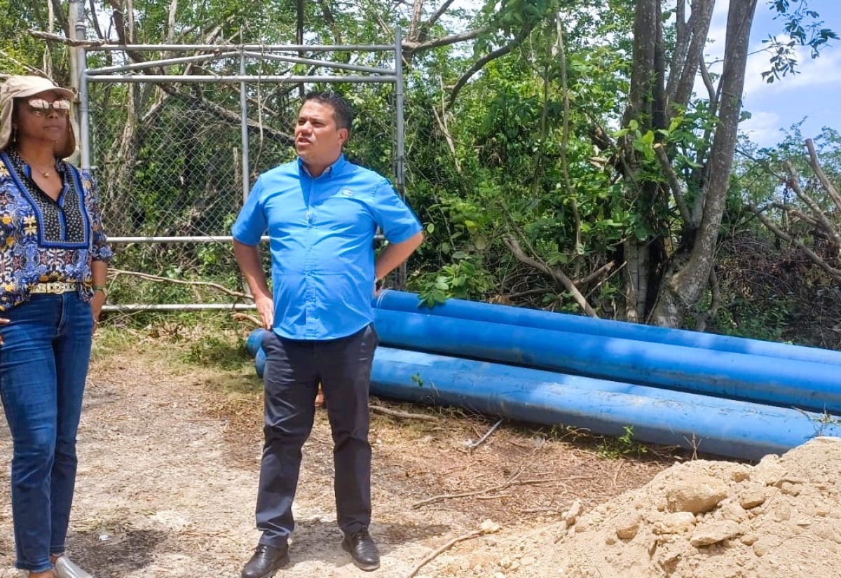 Minister without Portfolio in the Ministry of Economic Growth and Job Creation, Senator the Hon. Matthew Samuda (right), converses with Minister of Legal and Constitutional Affairs and Member of Parliament for St. James West Central, Hon. Marlene Malahoo Forte, during a visit to the site of the National Water Commission