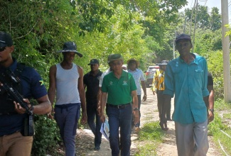 Minister of National Security, Hon. Dr. Horace Chang (centre), tours sections of Paradise, Norwood and Glendevon in Montego Bay, St. James, on August 23.