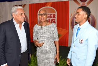 Minister of Education and Youth, Hon. Fayval Williams, speaks with 2024 Burger King Scholarship awardee, Janoy McRae (right), and Group Chairman, Restaurants Associates Limited, Richard Lake, during the recent scholarship awards presentation ceremony at the Terra Nova All-Suite Hotel in St. Andrew.