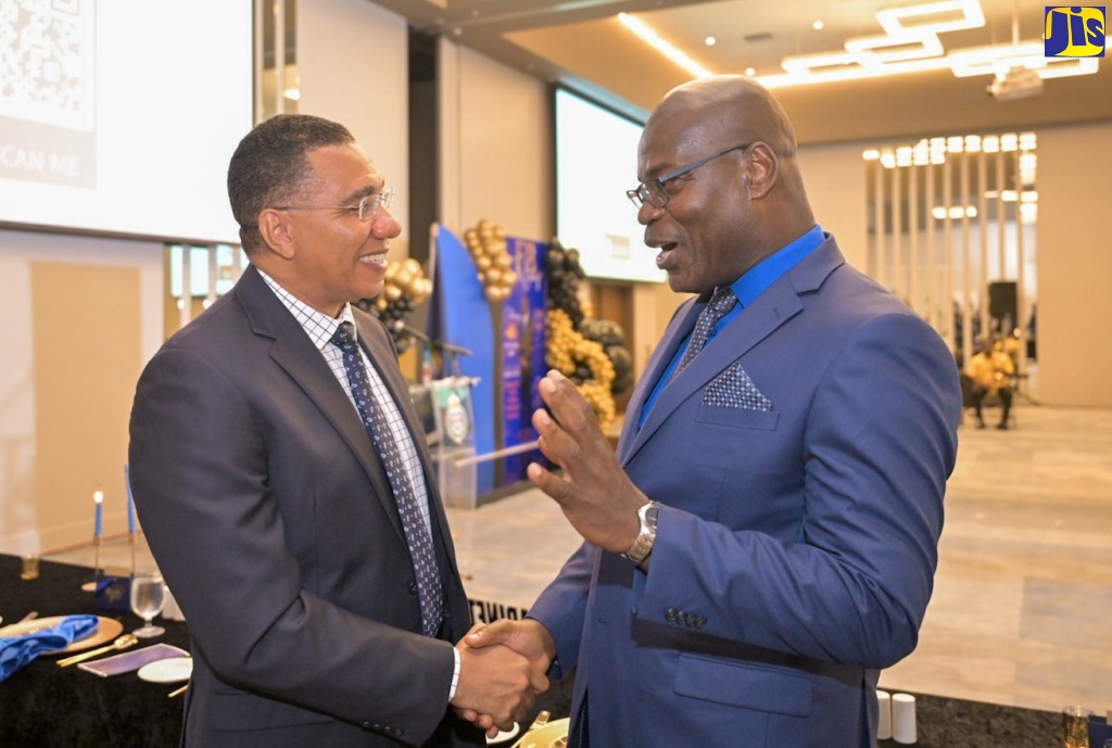 Prime Minister, the Most Hon. Andrew Holness (left), engages in conversation with outgoing Deputy Commissioner of Police (DCP) Fitz Bailey, at a retirement function for the veteran policeman, held on Friday (September 6), at the AC Mariott Hotel, in New Kingston.