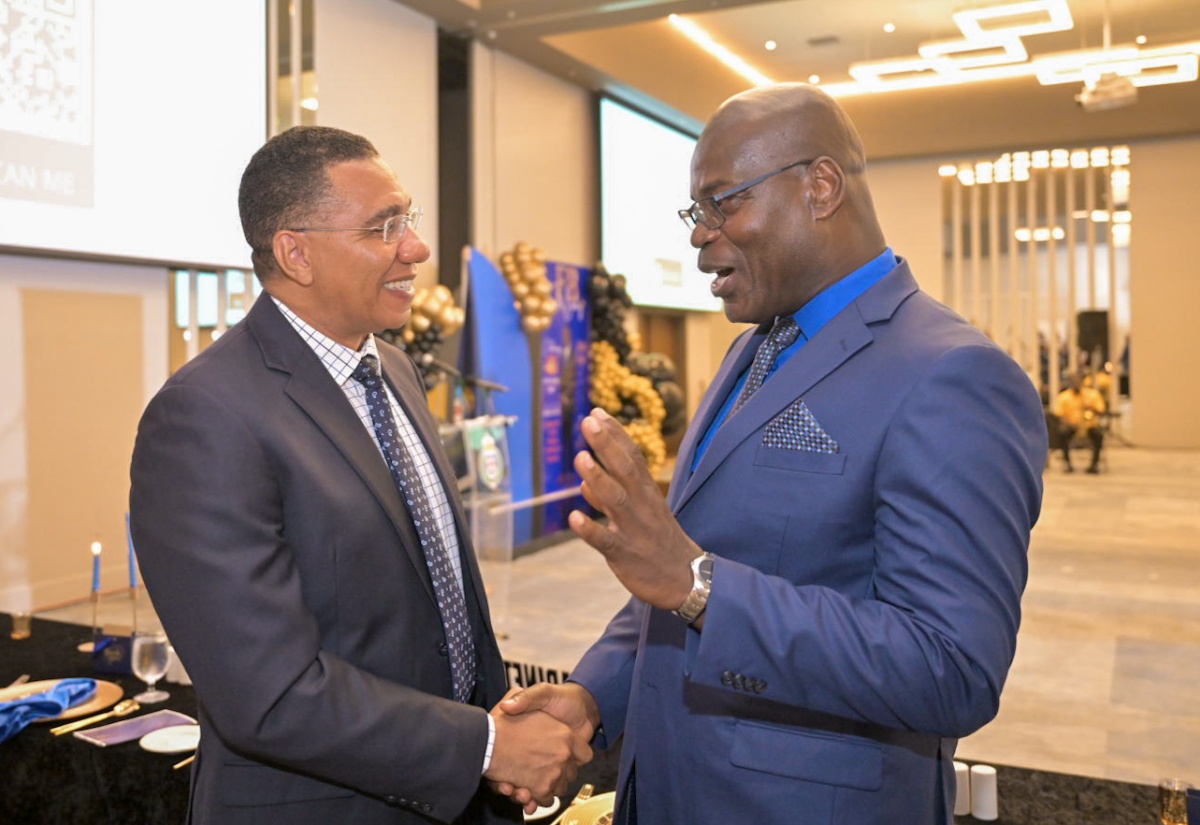 Prime Minister, the Most Hon. Andrew Holness (left), engages in conversation with outgoing Deputy Commissioner of Police (DCP) Fitz Bailey, at a retirement function for the veteran policeman, held on Friday (September 6), at the AC Mariott Hotel, in New Kingston.