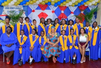 Principal of Louise Bennett-Coverley Primary School, Sheena Taylor Morgan (right, seated), Senior Teacher and Grade One and Six Coordinator, Michelle Barrett-Cain (left, seated), and poet and storyteller, Dr. Amina Blackwood Meeks (fourth right, seated), with the institution’s 2024 graduating class.

